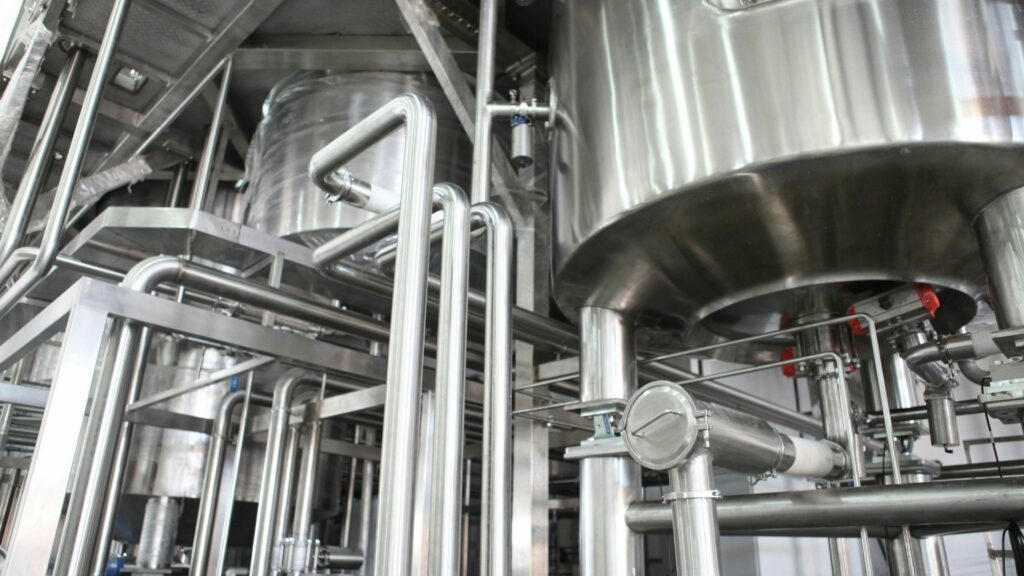 Stainless steel piping and multi-cartridge filter housing installation inside an industrial processing plant